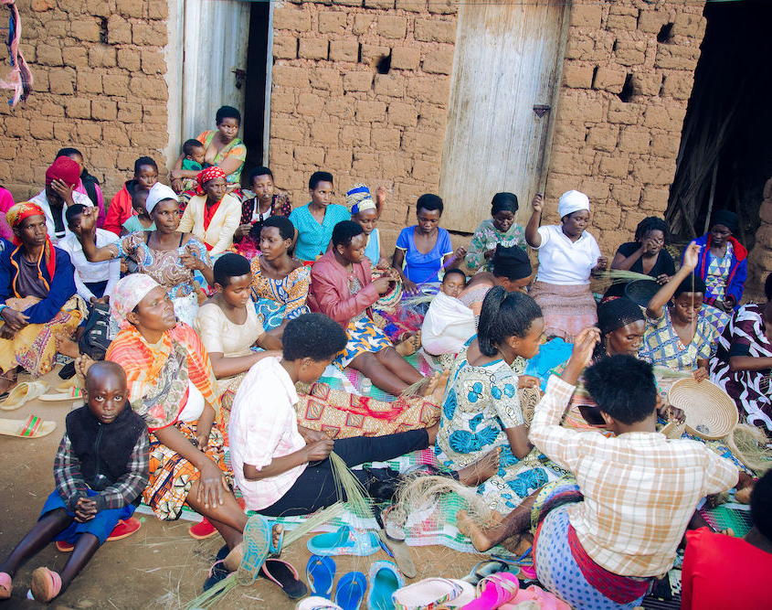 Women gathering to weave baskets and share their stories with each other.