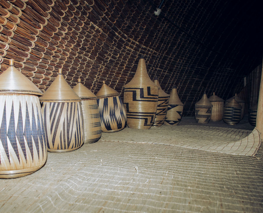 National Museum of Rwanda. Inside of King's house with storage baskets and grass mattings.